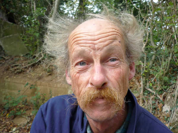 A picture of Simon with a moustache and wild hair